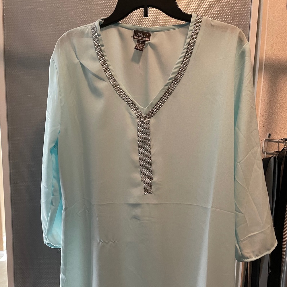 Large, light blue, half sleeve blouse.